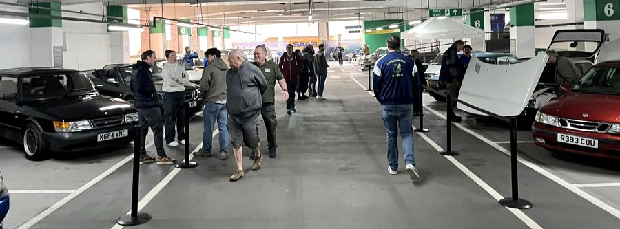 Visitors and cars inside the display area.