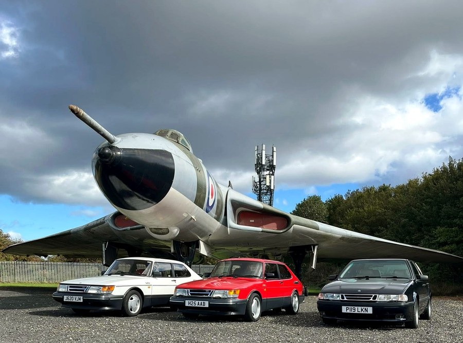 Three Saabs posed under the Vulcan.